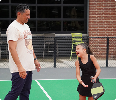 Man and Daughter playing pickleball